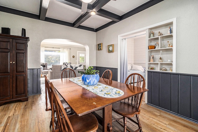 dining room with beamed ceiling, light hardwood / wood-style floors, and coffered ceiling