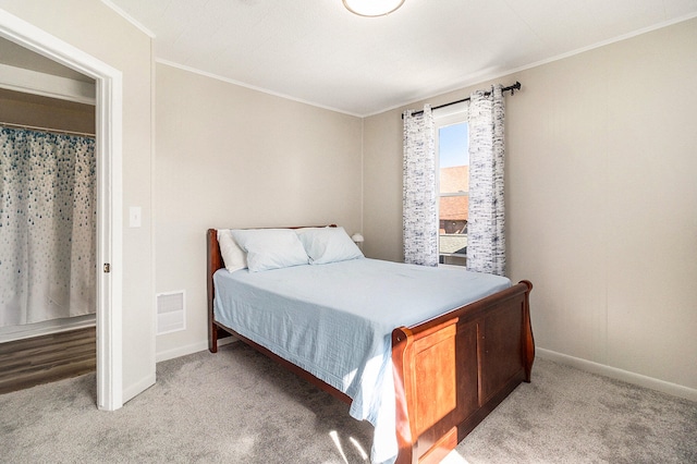 carpeted bedroom with ornamental molding