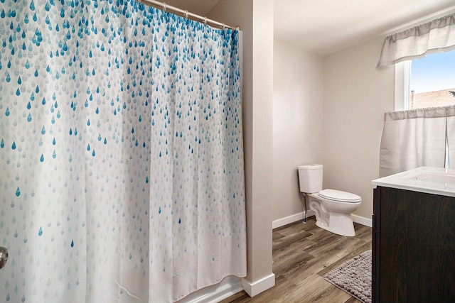 bathroom featuring hardwood / wood-style floors, vanity, and toilet