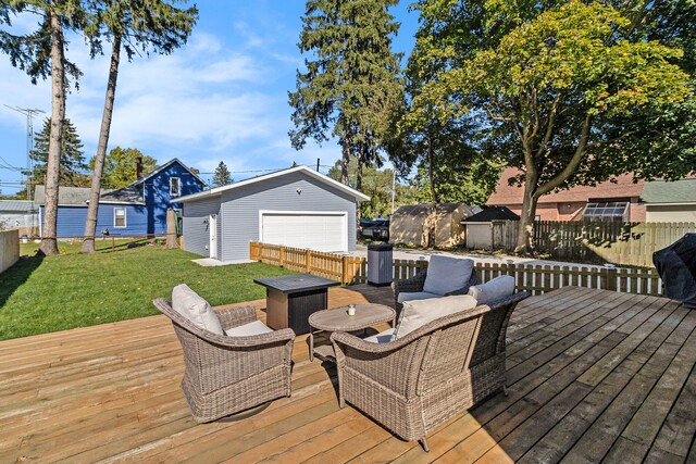 deck with a lawn, a garage, and an outbuilding