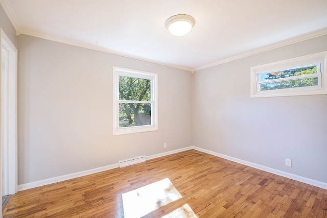 unfurnished room featuring light wood-type flooring, baseboard heating, and crown molding