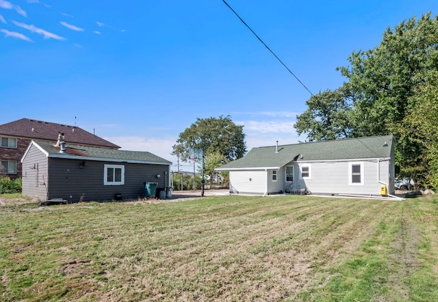 rear view of property with a lawn