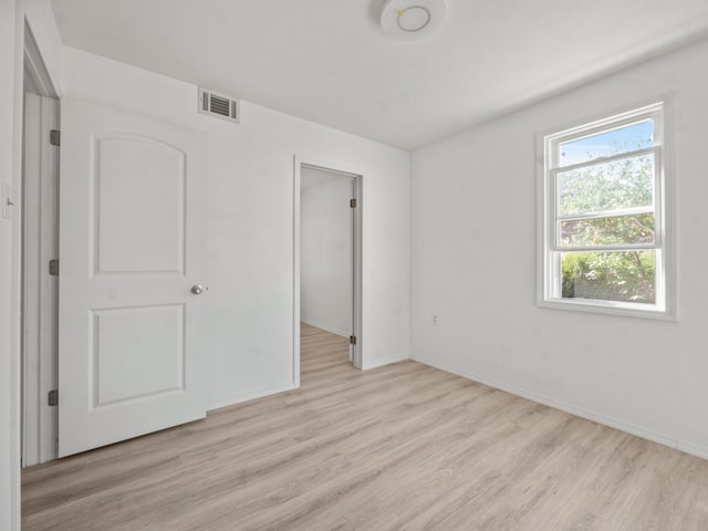 unfurnished bedroom featuring light wood-type flooring