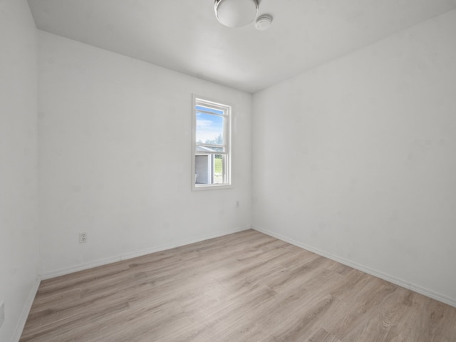 unfurnished room with light wood-type flooring