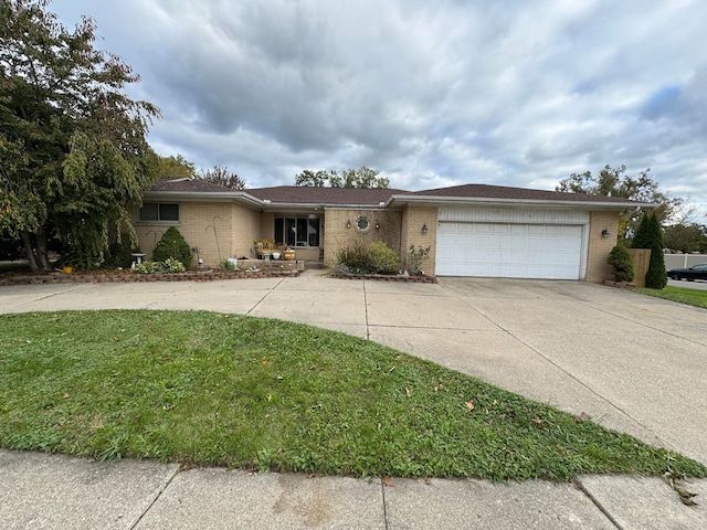 ranch-style house with a front lawn, brick siding, a garage, and driveway