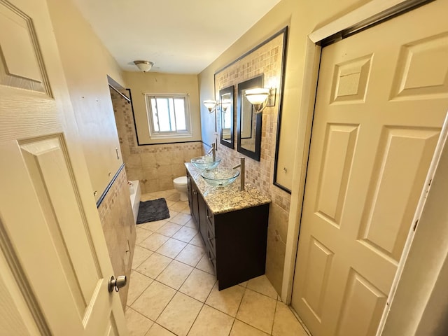 full bathroom featuring vanity, bathing tub / shower combination, tile walls, tile patterned flooring, and toilet