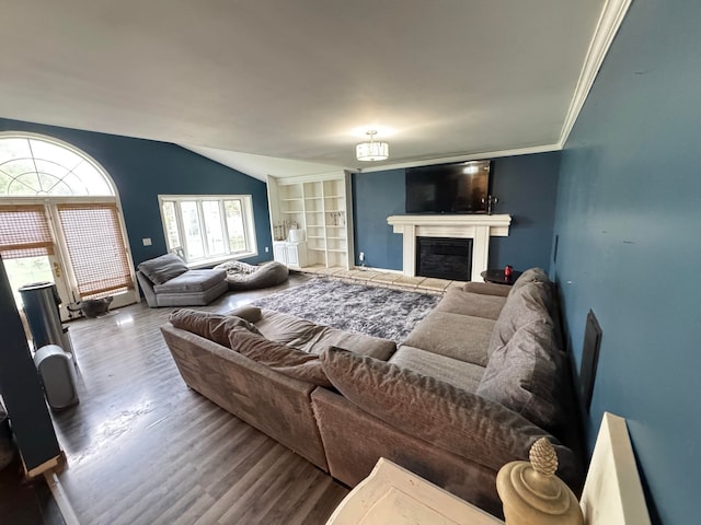 living room featuring a chandelier, hardwood / wood-style floors, ornamental molding, and lofted ceiling