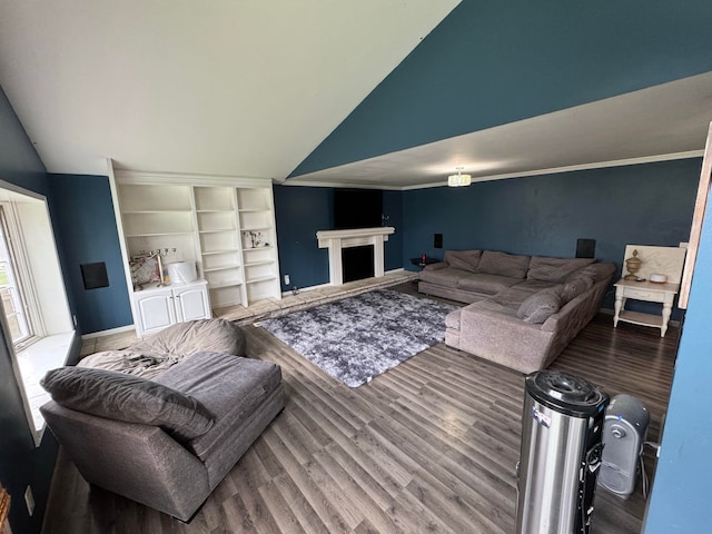 living room with ornamental molding, vaulted ceiling, and hardwood / wood-style flooring