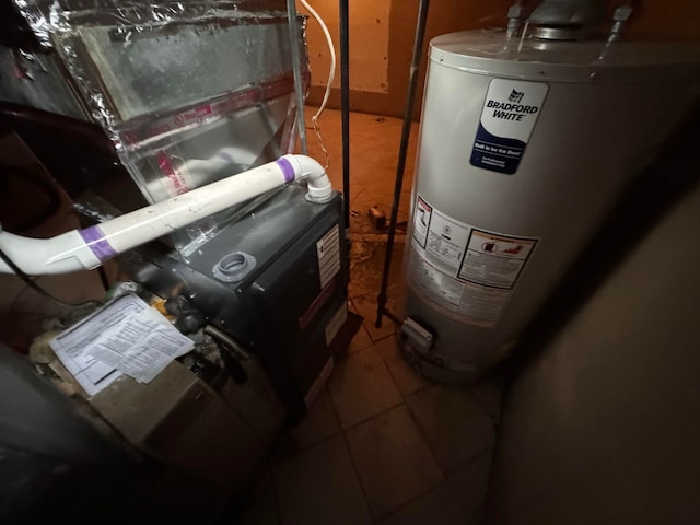 utility room with heating unit and water heater