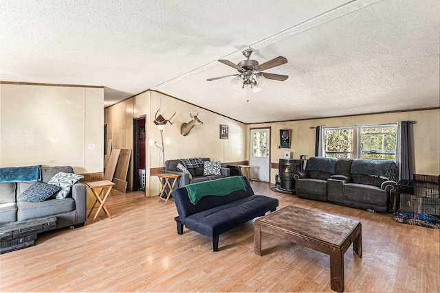 living room featuring ceiling fan, a textured ceiling, and light wood-type flooring