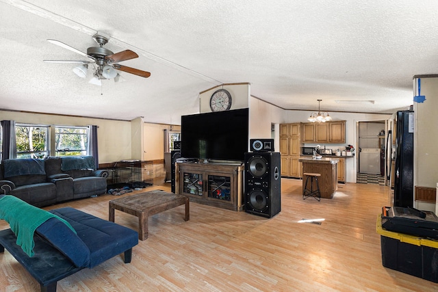 living room featuring stacked washer and clothes dryer, a textured ceiling, and light wood-type flooring