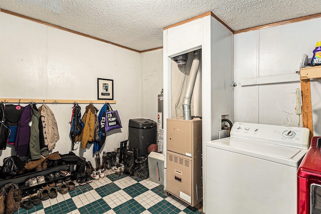 laundry area with a textured ceiling, washer / clothes dryer, and crown molding