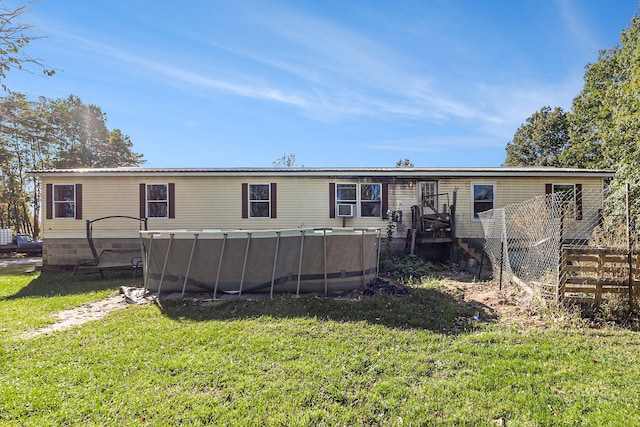 back of house featuring a yard