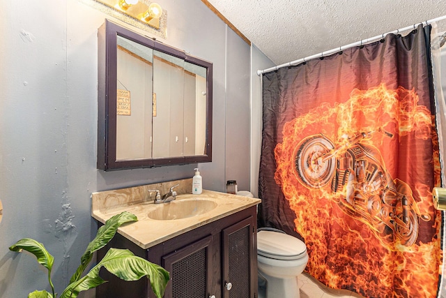 bathroom featuring vanity, toilet, and a textured ceiling