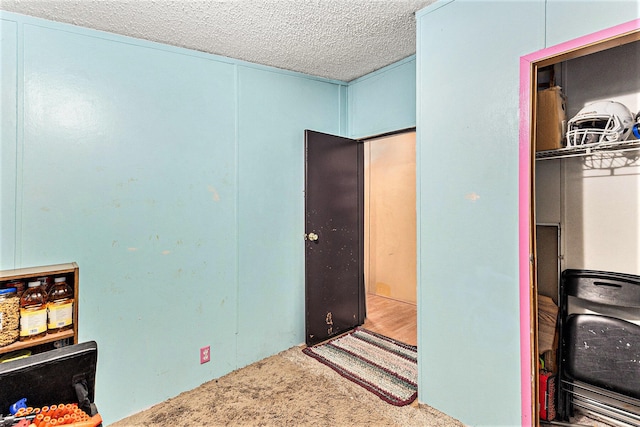 carpeted bedroom featuring a textured ceiling