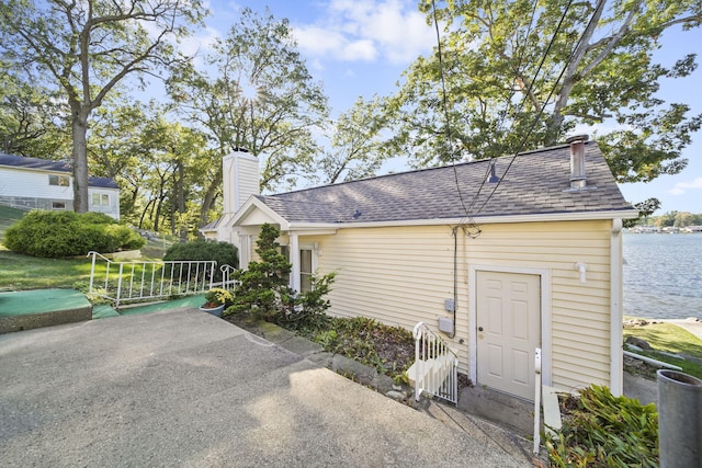 view of side of home featuring a water view