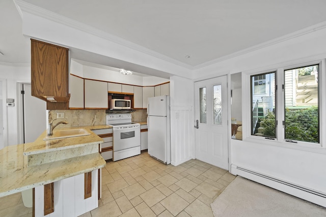 kitchen with white appliances, sink, decorative backsplash, a baseboard radiator, and a breakfast bar area