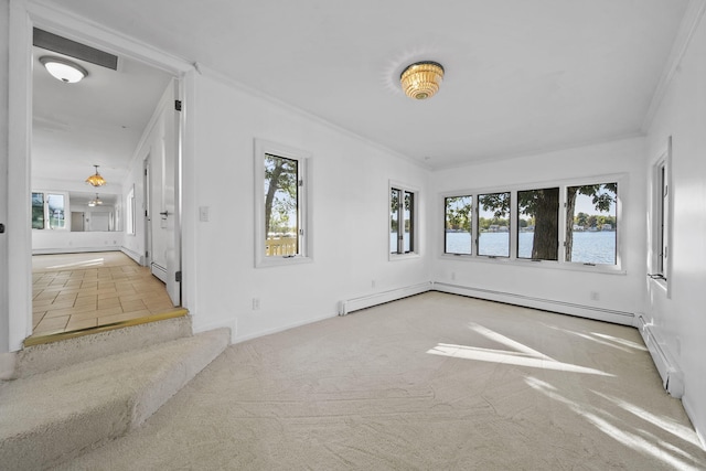 unfurnished room featuring plenty of natural light, a water view, ornamental molding, and light carpet