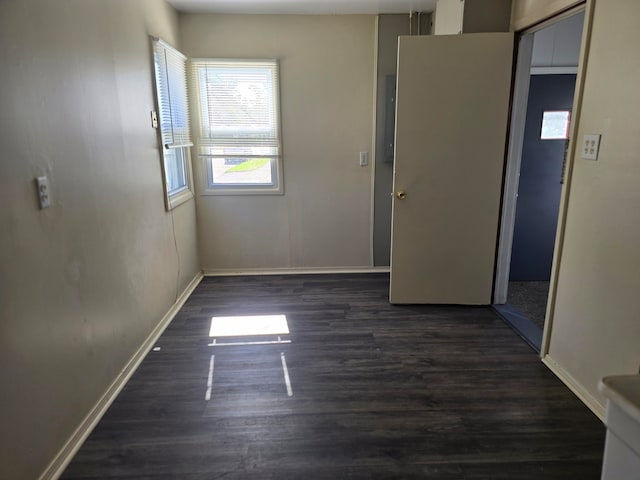 unfurnished room with dark hardwood / wood-style floors