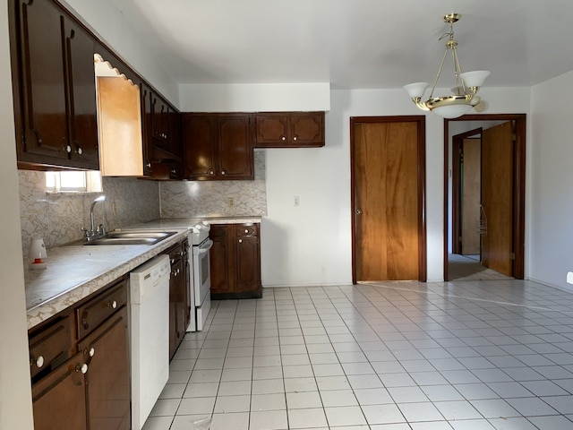 kitchen with decorative backsplash, light tile patterned floors, hanging light fixtures, and an inviting chandelier