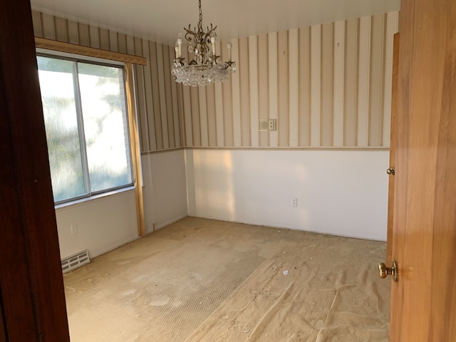 empty room featuring a chandelier