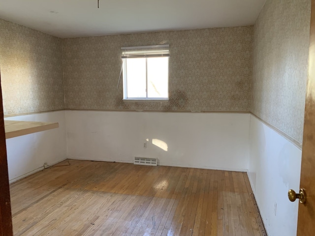 spare room featuring wood-type flooring