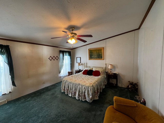 bedroom with ceiling fan, dark carpet, crown molding, and a textured ceiling