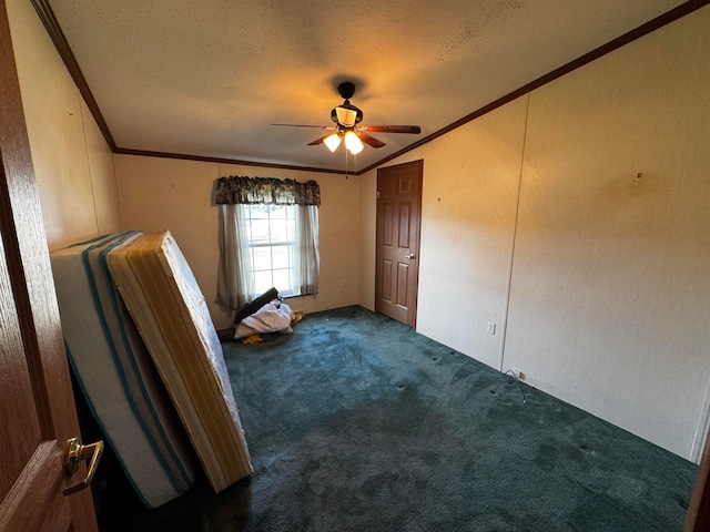 carpeted empty room with ceiling fan, a textured ceiling, and ornamental molding