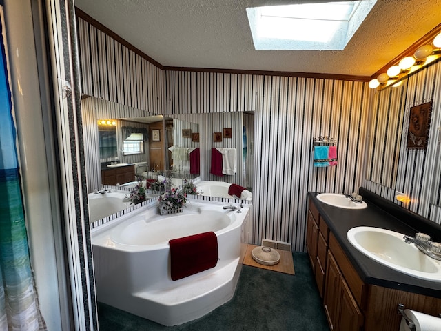 bathroom featuring crown molding, a textured ceiling, a bathtub, vanity, and vaulted ceiling with skylight