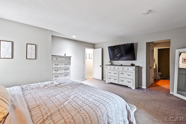 carpeted bedroom with a textured ceiling and ensuite bath