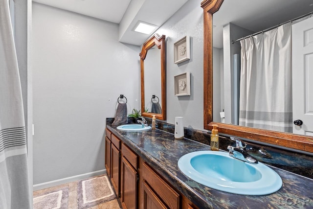 bathroom featuring tile patterned floors, vanity, and a shower with curtain