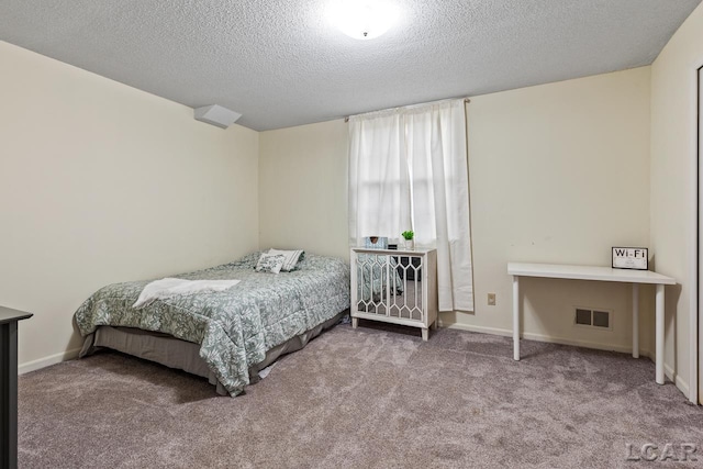 bedroom with carpet flooring and a textured ceiling