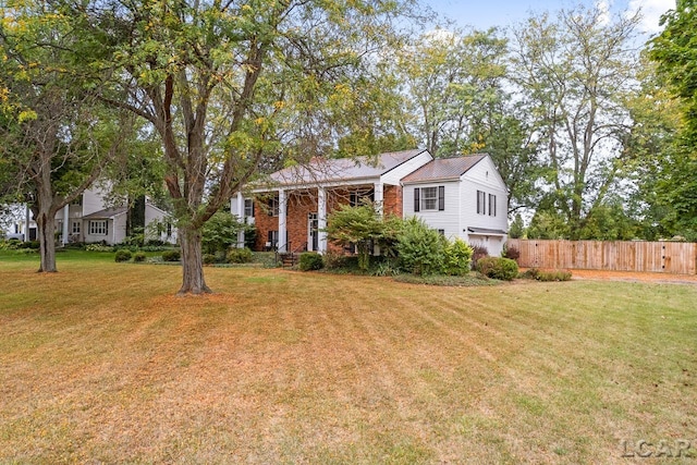 view of front of home with a front lawn and a garage