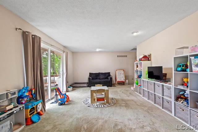 game room featuring carpet and a textured ceiling