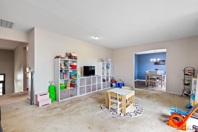 recreation room with carpet floors and an inviting chandelier