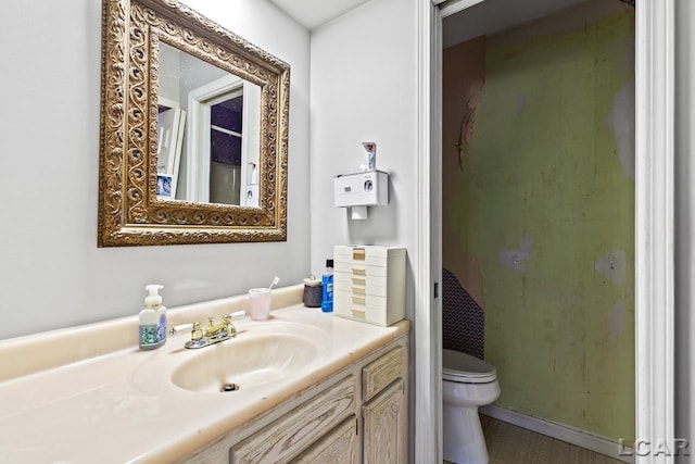 bathroom featuring vanity and toilet