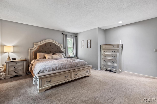 bedroom with carpet flooring and a textured ceiling