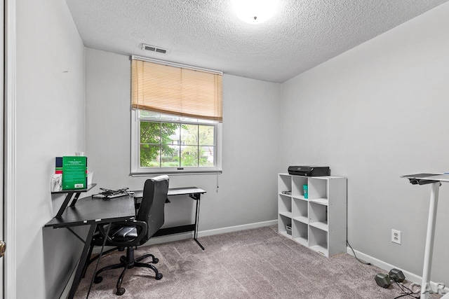 office featuring carpet flooring and a textured ceiling