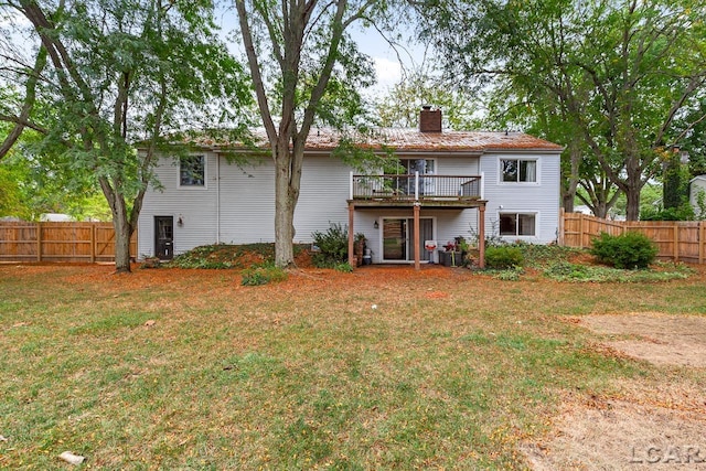 back of house featuring a yard and a wooden deck