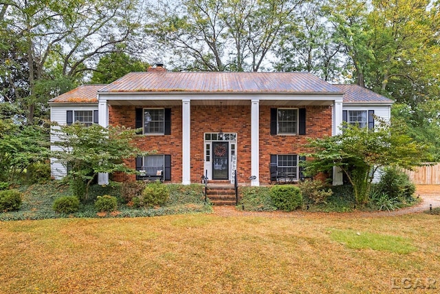 raised ranch with a front yard