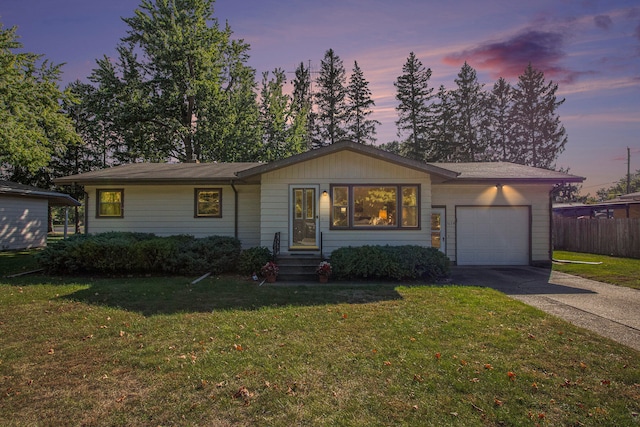 ranch-style house with a lawn and a garage