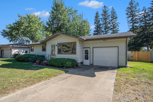 ranch-style house with a garage and a front lawn