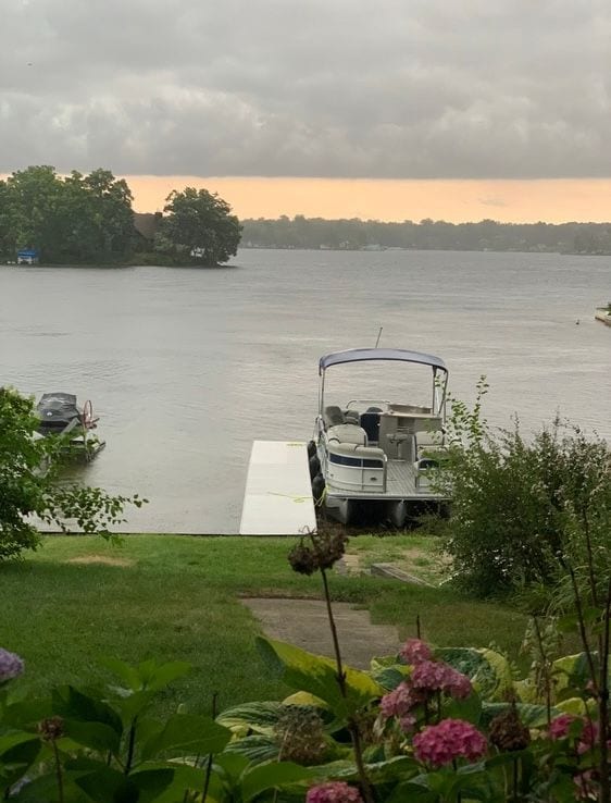 view of dock featuring a yard and a water view