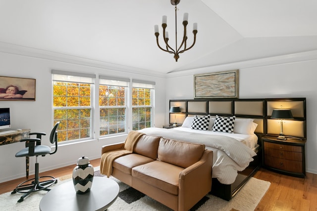 bedroom featuring multiple windows, lofted ceiling, a notable chandelier, and light wood-type flooring