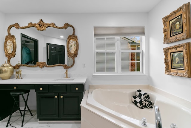 bathroom featuring vanity and tiled tub