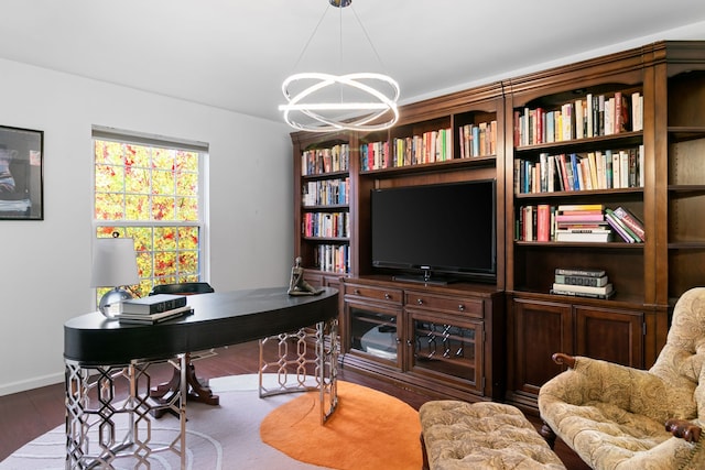 home office with a chandelier and hardwood / wood-style floors