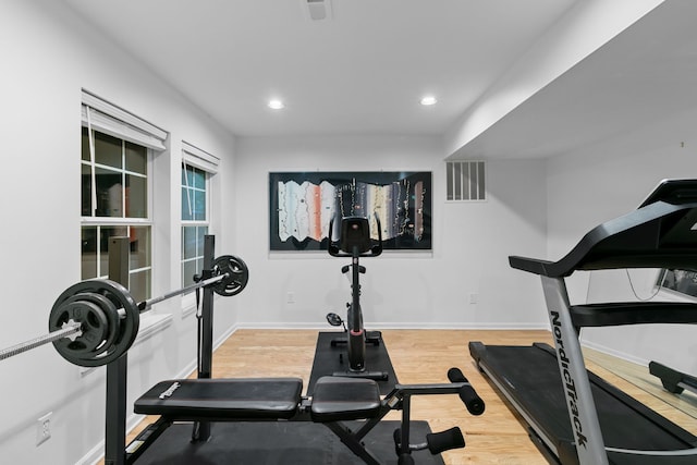 workout room featuring light hardwood / wood-style floors