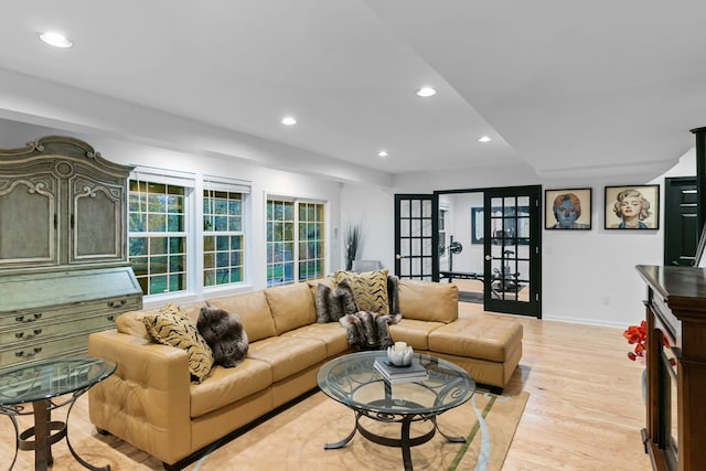 living room with french doors and light wood-type flooring