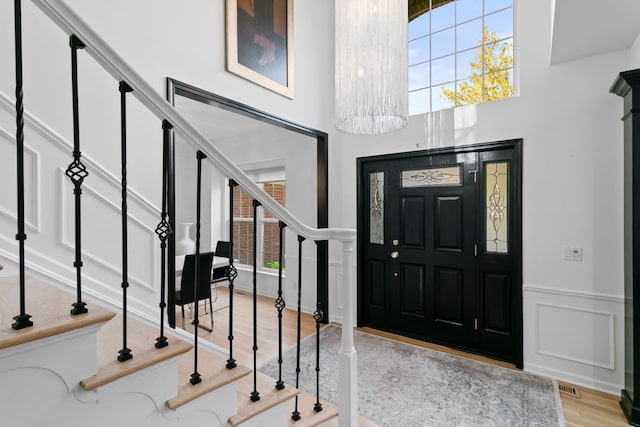 entrance foyer with a notable chandelier and light wood-type flooring