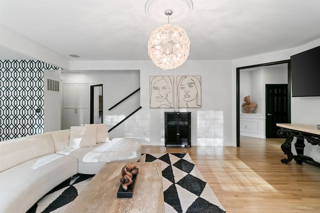 living room featuring a chandelier and light hardwood / wood-style floors